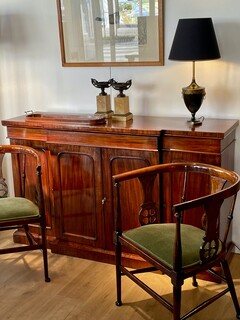An English 19th Century Mahogany Breakfront Side Board and Two Edwardian Mahogany Tub Chairs