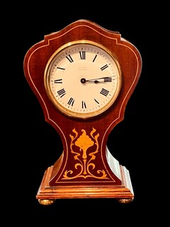 An English Edwardian Mahogany Mantel Clock with Floral Satinwood Inlay.